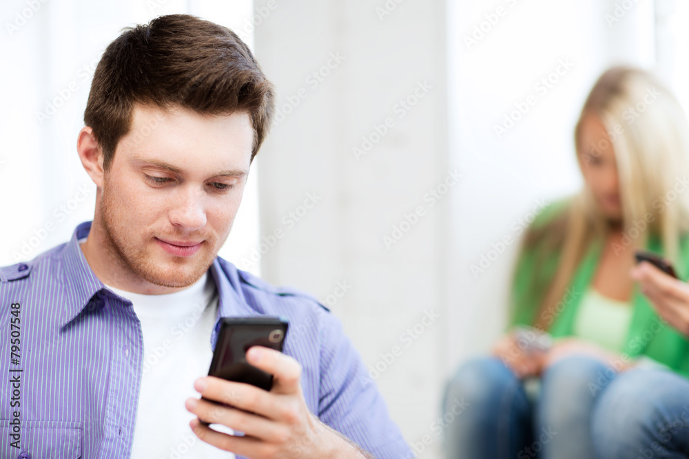 student looking at phone and tiping student looking at phone and tiping