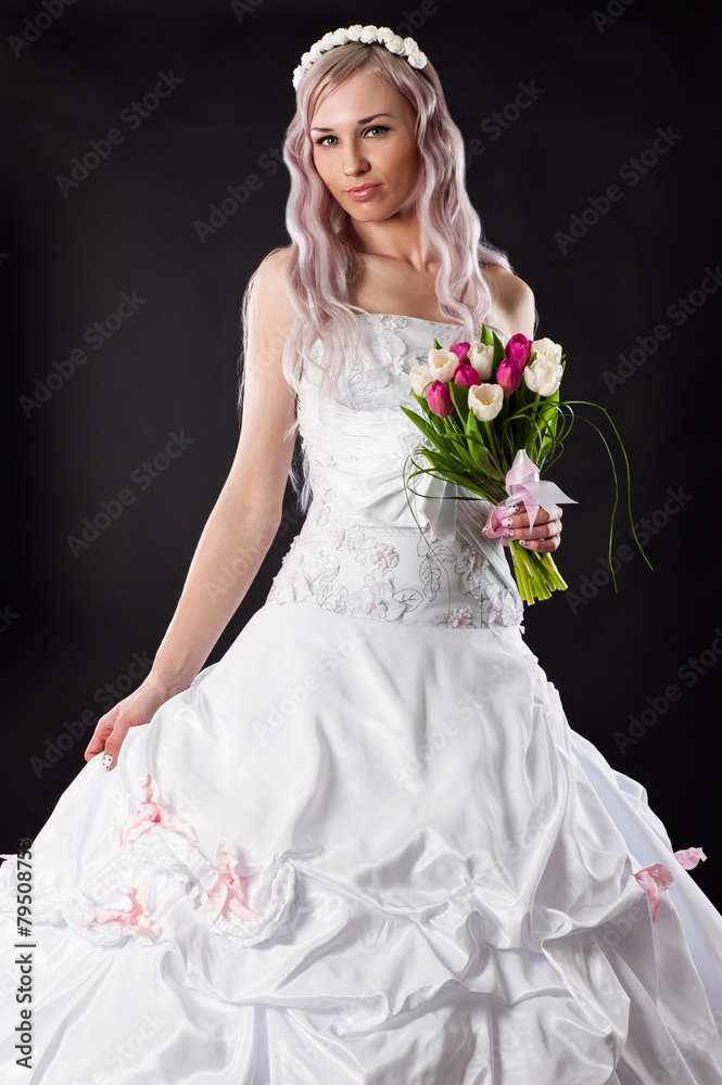 attractive bride in a wedding dress with a bouquet of tulips