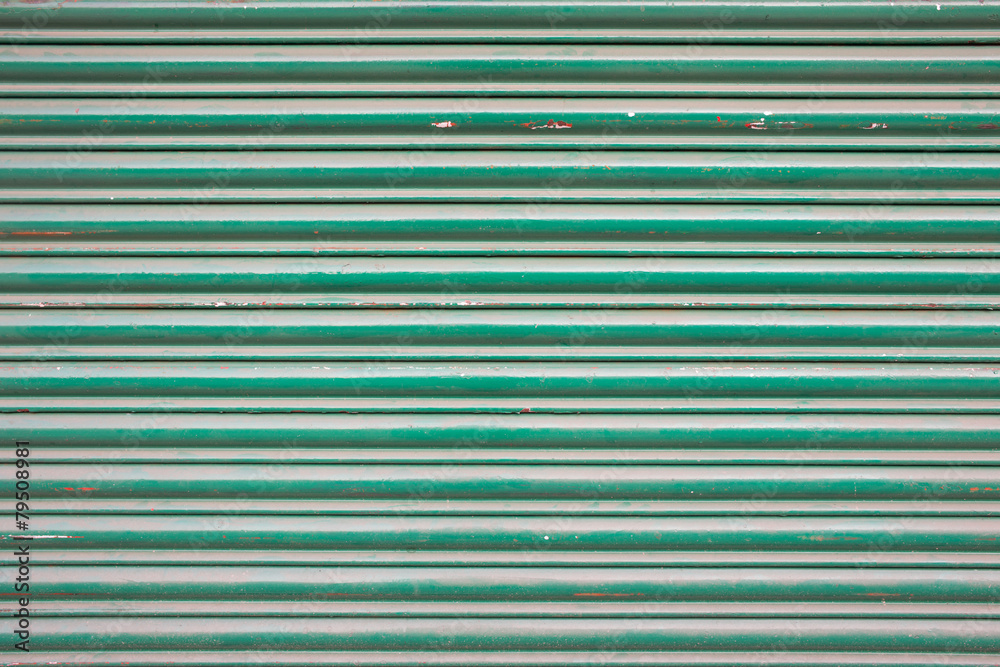 Obraz premium Large green metallic tin stripy fence background with scratches