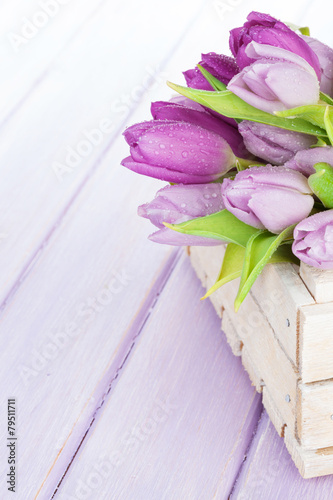 Fototapeta Naklejka Na Ścianę i Meble -  Purple tulips box over wooden table