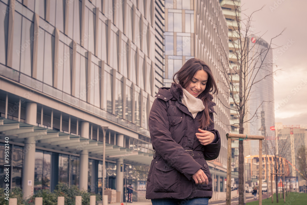 Fototapeta premium Young beautiful girl posing in the city streets