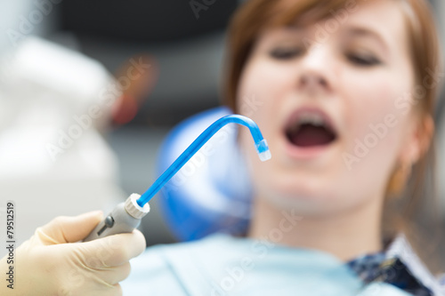 Bild auf Leinwand saliva ejector on background woman