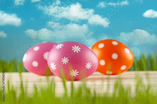 Colored Easter eggs on blue sky background