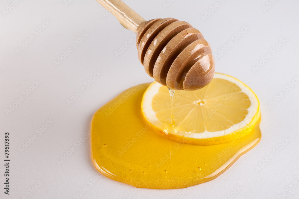 honey dripping on slice of lemon isolated white honey dripping on slice of lemon isolated white