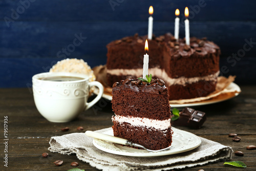 Delicious chocolate cake on table on blue background