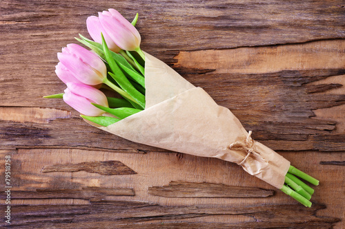 Fototapeta Naklejka Na Ścianę i Meble -  Beautiful pink tulips in paper on wooden background