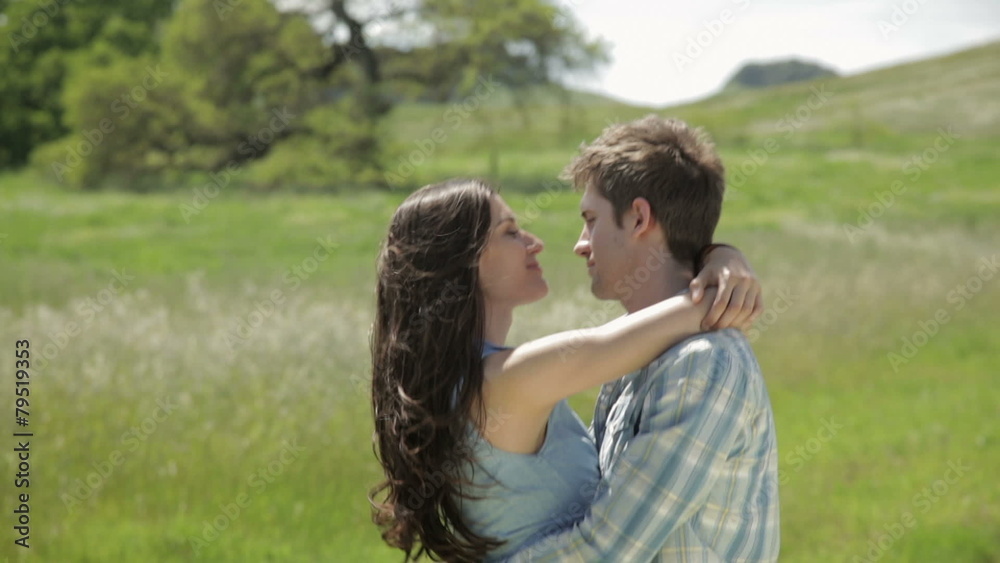 Young couple hugging and talking to each other in nature Young couple hugging and talking to each other in nature