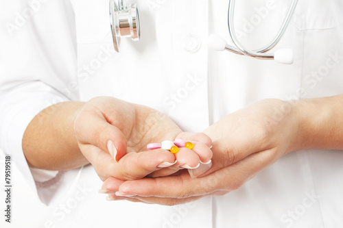 pills in a hand on a white background