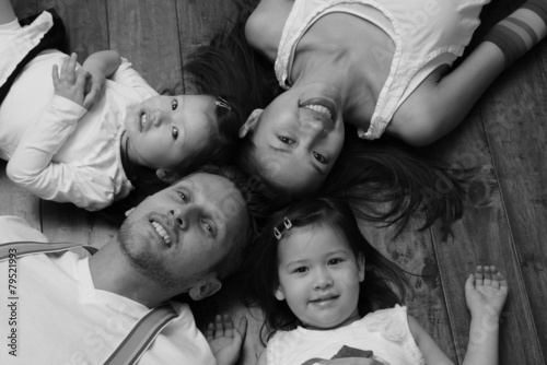 Fotografie Portrait of Asian American family laying on ground