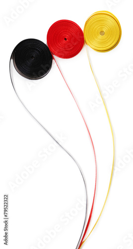 Colorful red with yellow and black ribbons isolated on white