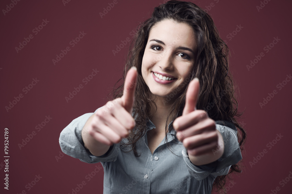 Cheerful woman thumbs up