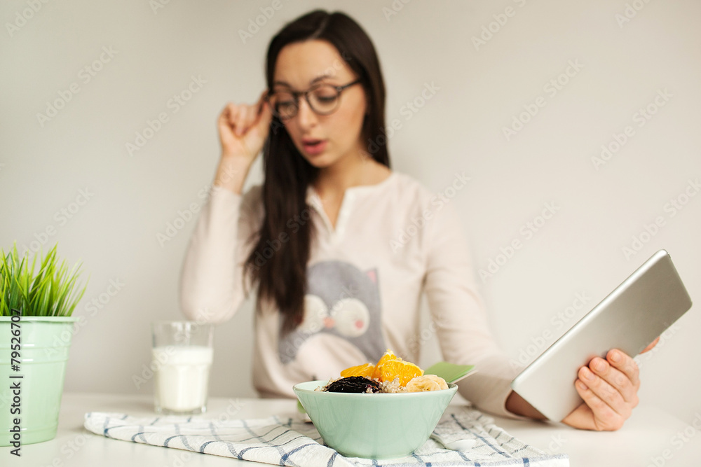 Woman making notes with tablet and healthy food on table Woman making notes with tablet and healthy food on table