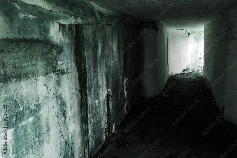 Empty abandoned bunker interior with glowing end