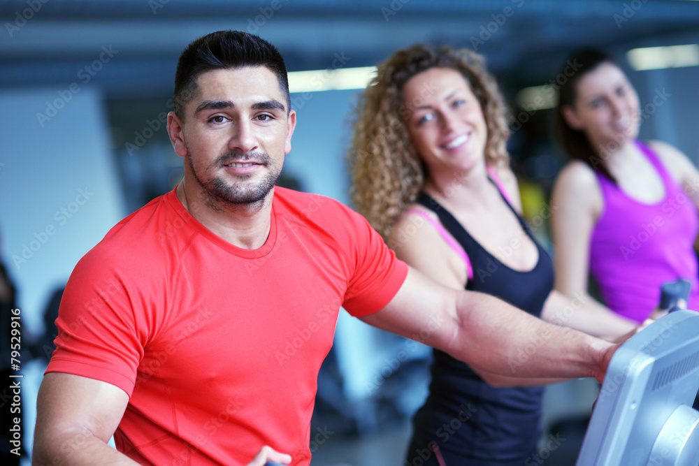 Group of people running on treadmills