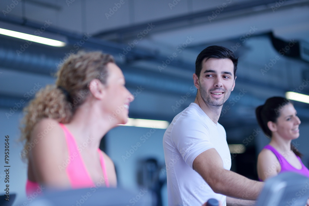 Group of people running on treadmills Group of people running on treadmills