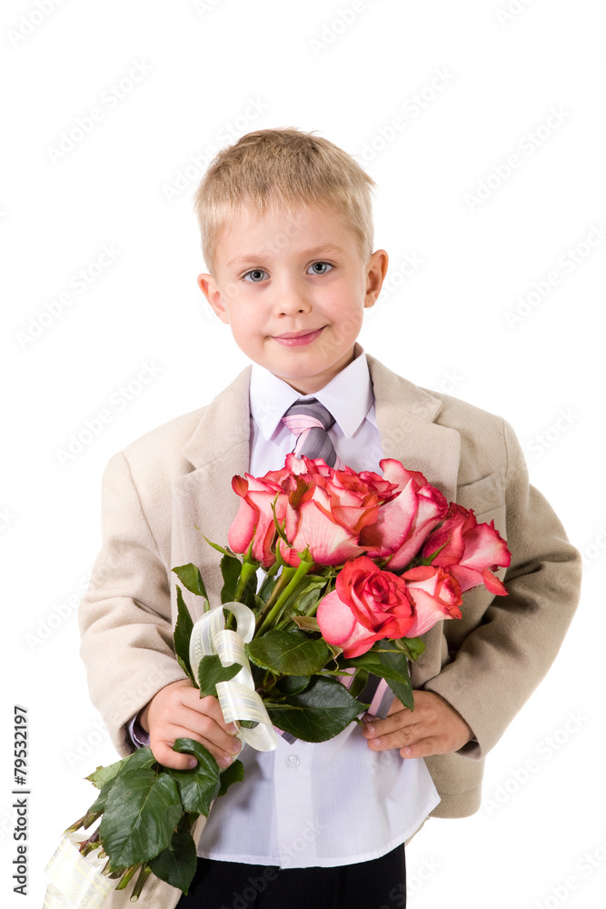 Cute little gentleman standing with big bouquet of red roses Cute little gentleman standing with big bouquet of red roses