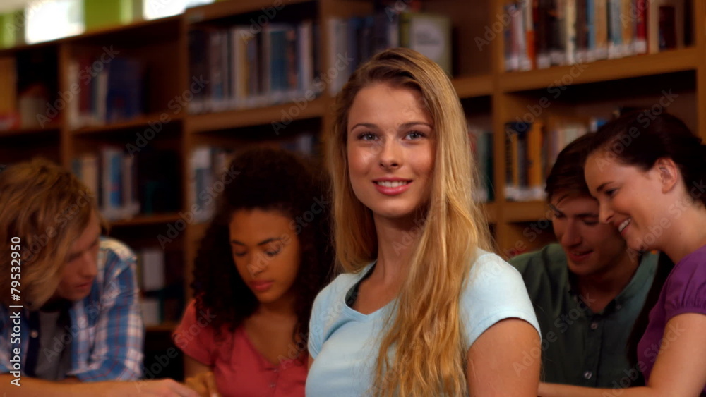 Student smiling at camera in library Student smiling at camera in library