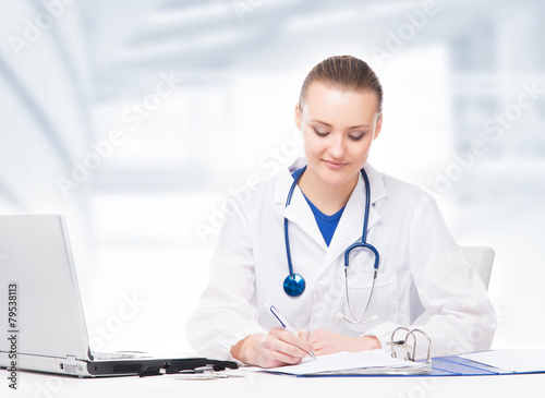 Young, professional and cheerful female doctor working in office