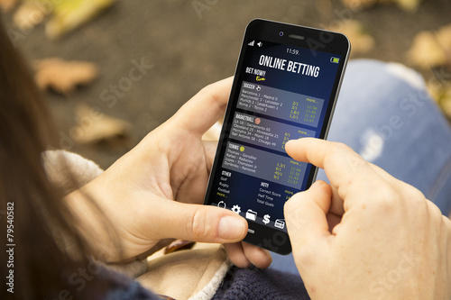 Obraz na płótnie woman betting online  in the park