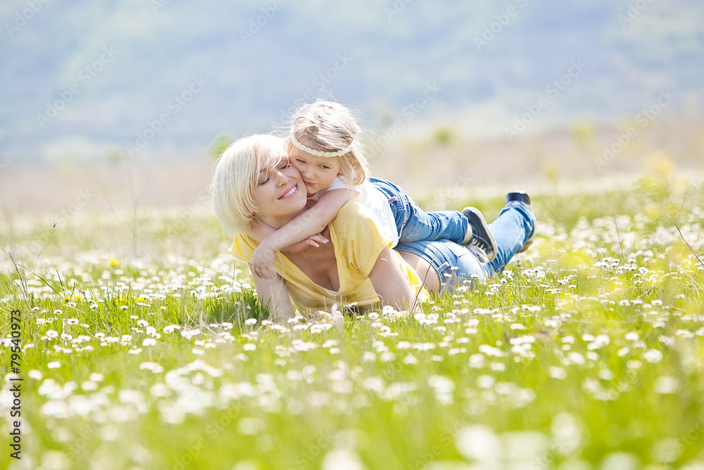 Fototapeta premium Happy woman with a child resting on the nature
