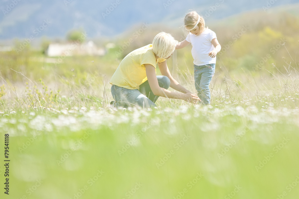 Fototapeta premium Happy woman with a child resting on the nature