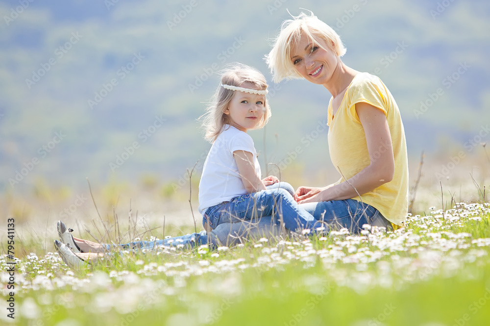 Fototapeta premium Happy woman with a child resting on the nature