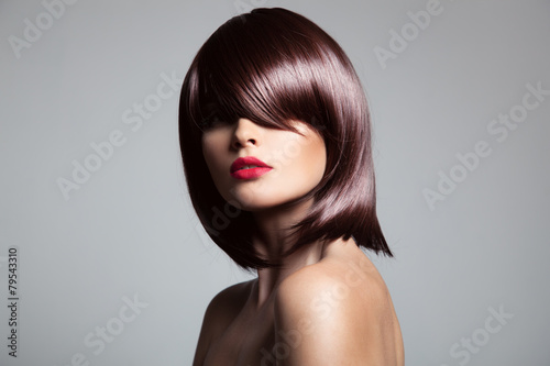 Beautiful model with perfect long glossy brown hair. Close-up po