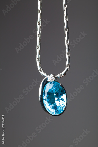 blue sapphire pendant on grey background