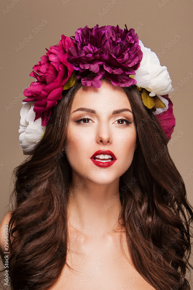 sexy model with curle hair and bright flowers on her head