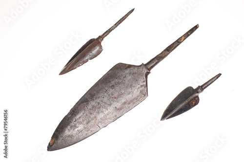 Three ancient arrowheads on a white background photo