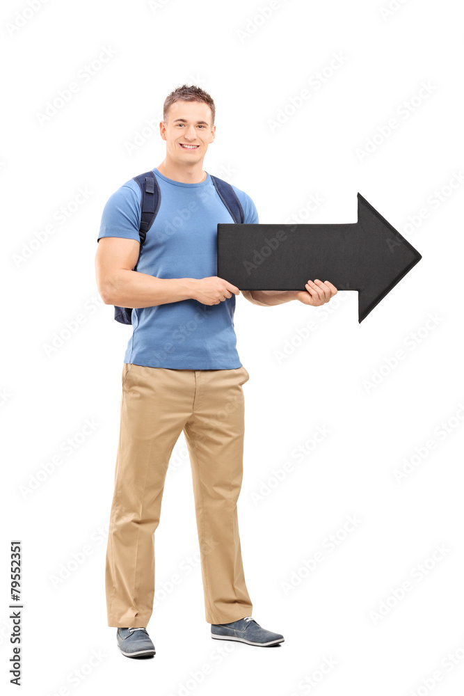 Young male student holding a big black arrow Young male student holding a big black arrow