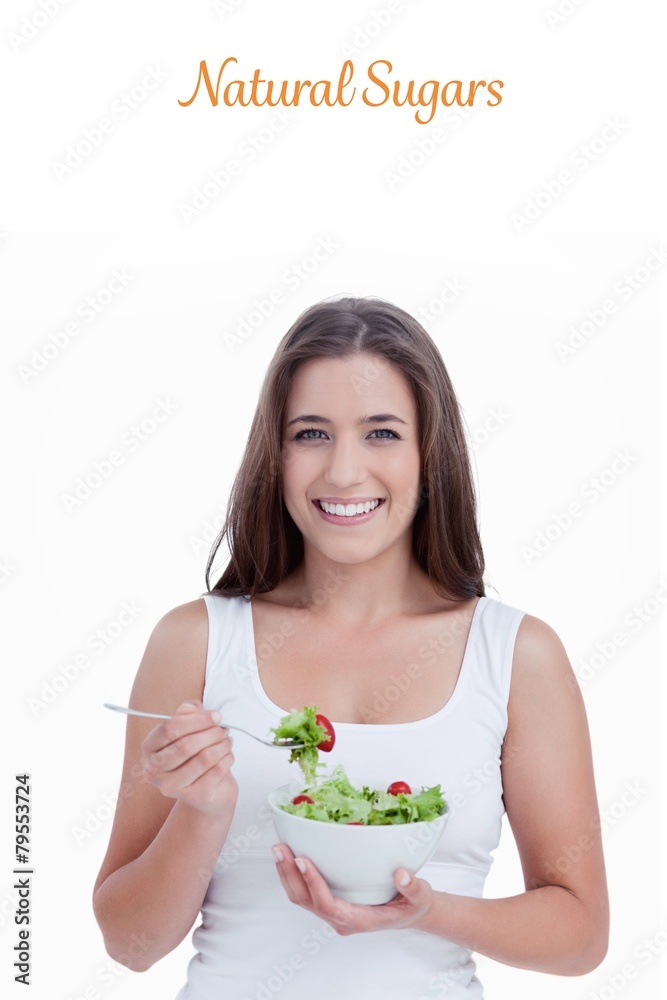 Natural sugars against smiling woman eating a salad Natural sugars against smiling woman eating a salad