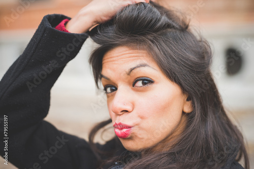 Portrait of young woman pouting in park