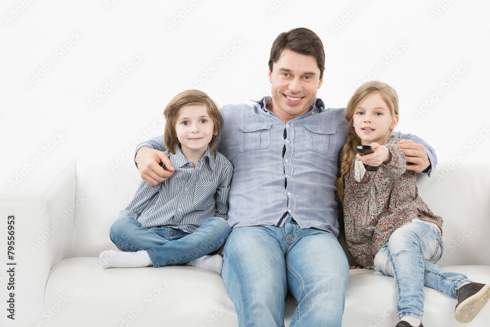 Family sitting on the couch watching television,