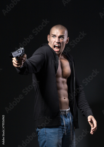 scared man shooting gun isolated on black background