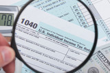 USA 1040 Tax Form with magnifying glass