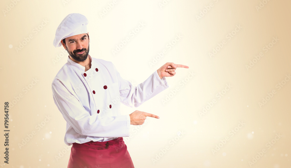Chef pointing to the lateral over white background Chef pointing to the lateral over white background