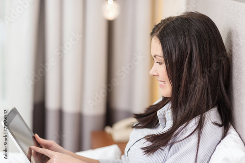 happy businesswoman with tablet pc in hotel room