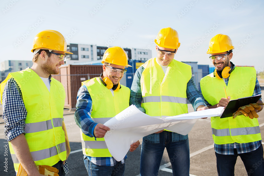 group of builders with tablet pc and blueprint group of builders with tablet pc and blueprint
