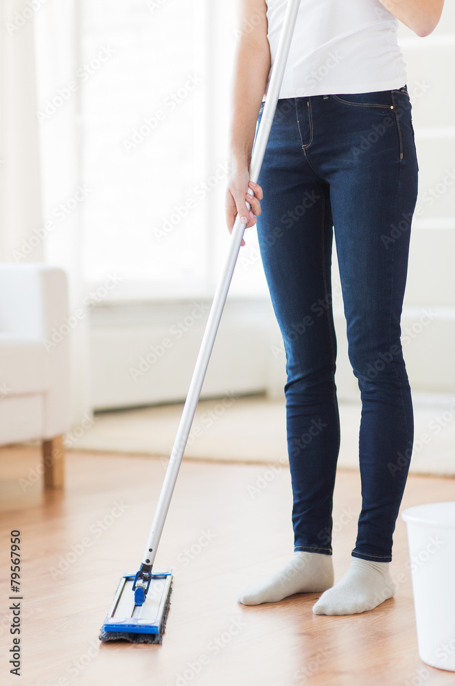close up of woman with mop cleaning floor at home close up of woman with mop cleaning floor at home