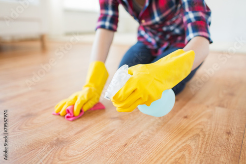 close up of woman with rag cleaning floor at home