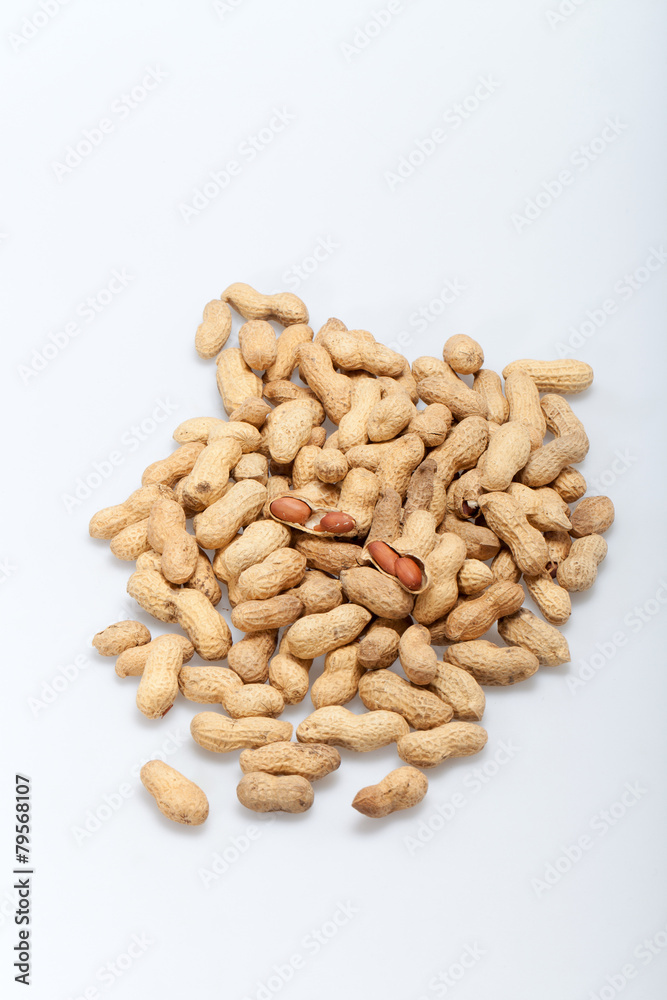 .Dried peanuts in closeup on the white background .Dried peanuts in closeup on the white background