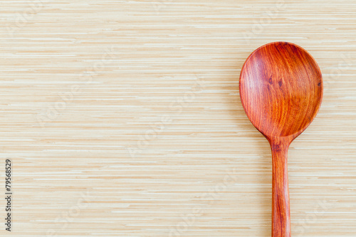 Wooden spoon on wooden background - concept for food and kitchen