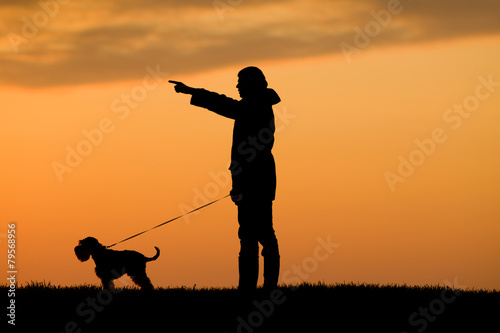 Silhouette of man and dog