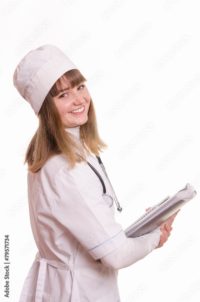 Health worker in white coat, hat stands with documents in hand Health worker in white coat, hat stands with documents in hand