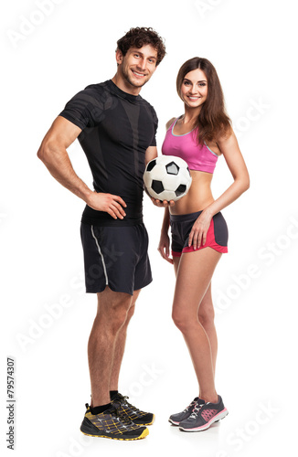 Athletic man and woman with ball on the white