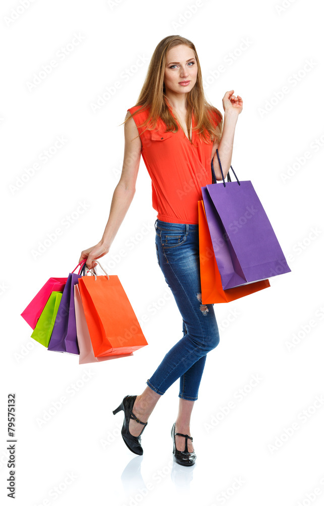 Happy caucasian woman holding shopping bags on white. Holidays c