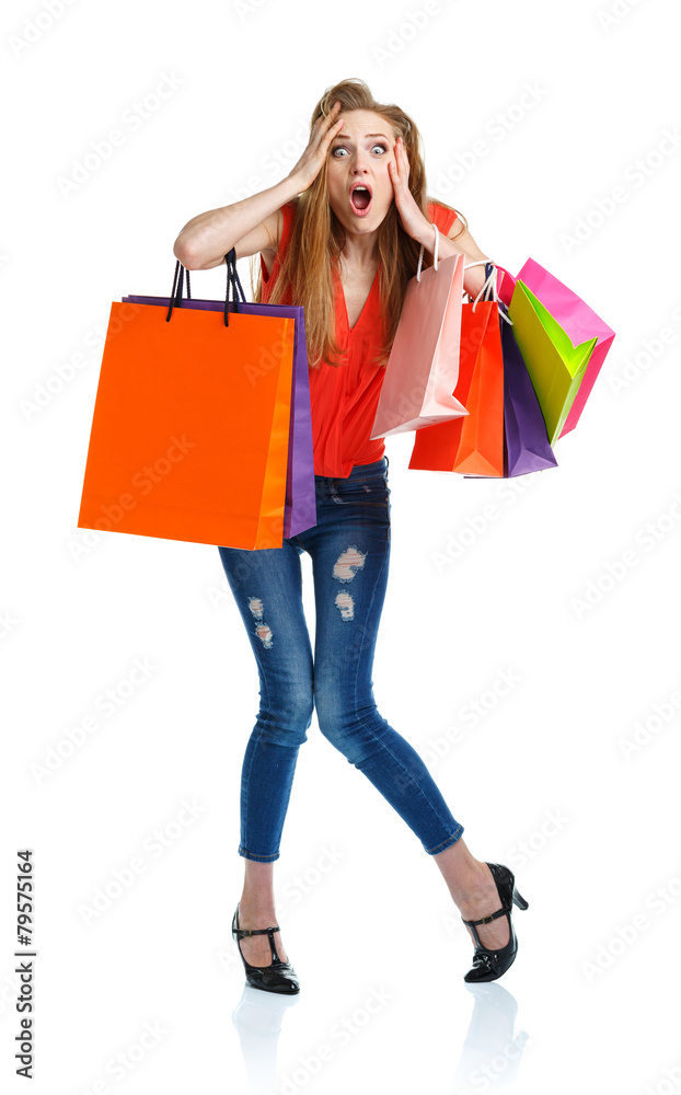 Young caucasian woman holding shopping bags on white background