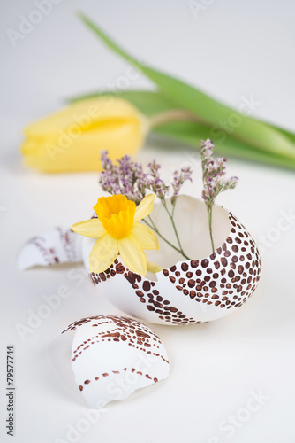 Easter decorations on neutral background in white  yellow and gr