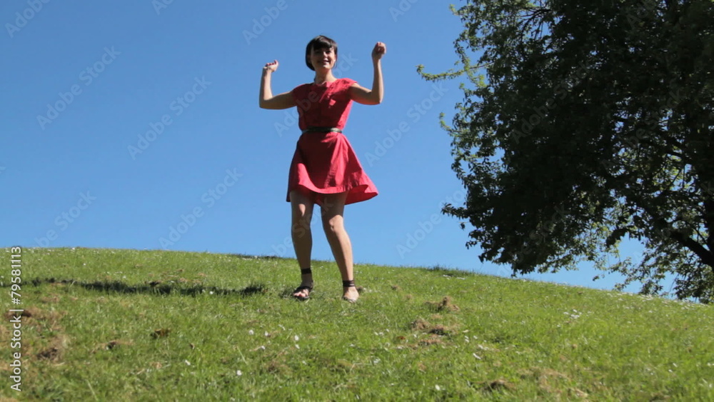 Female dancing and jumping on hill in park Female dancing and jumping on hill in park